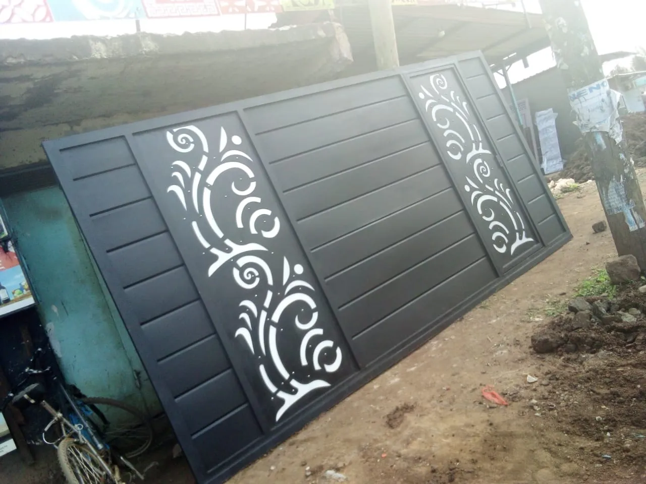 Black steel sliding gate panel with CNC floral pattern made in our Kimbo workshop