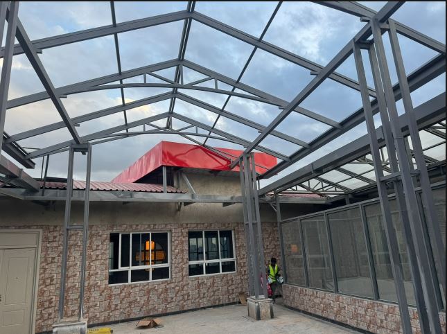 Industrial steel truss roof structure fabrication for a warehouse building